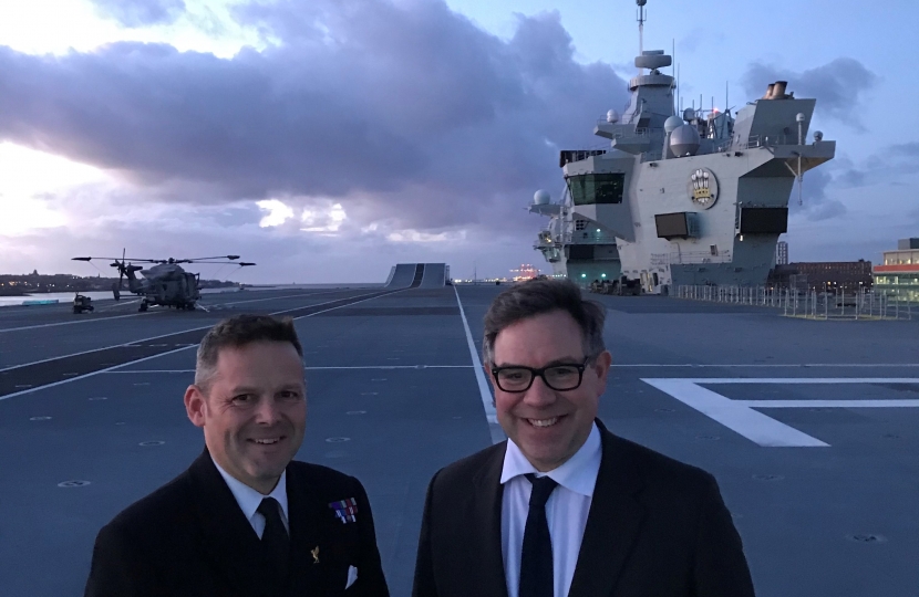 Jeremy Quin on the flight deck of HMS Prince of Wales one of two new aircraft carriers entering service with the Royal Navy.